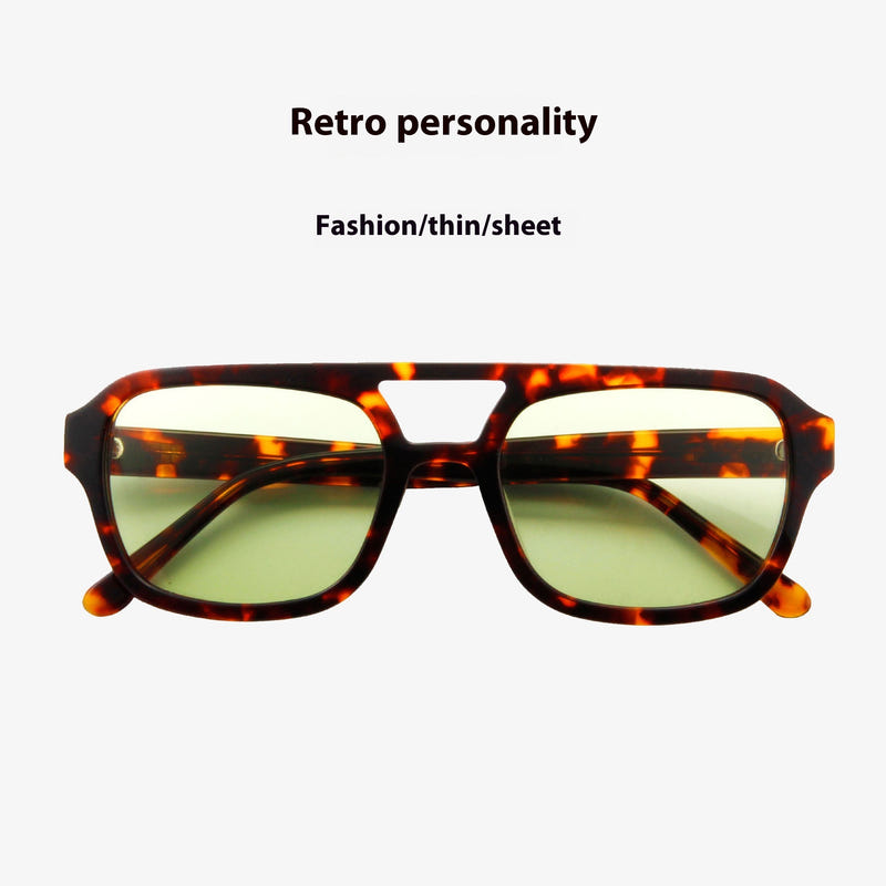 Tortoiseshell cat-eye sunglasses with green tinted lenses, front view