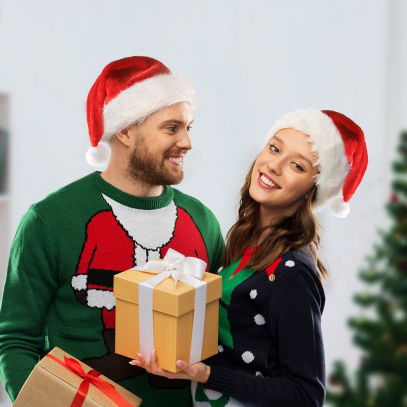 Two people wearing Christmas-themed outfits with a gift exchange.