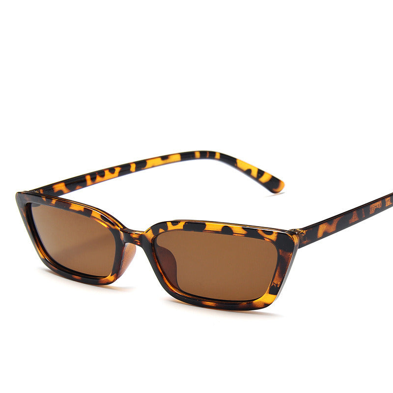 Sunglasses with tortoiseshell frame and brown lenses on a white background