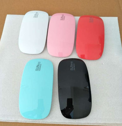 Five colorful Nail Drayer on a white paper background.