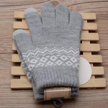Gray gloves with a pattern on a wooden surface