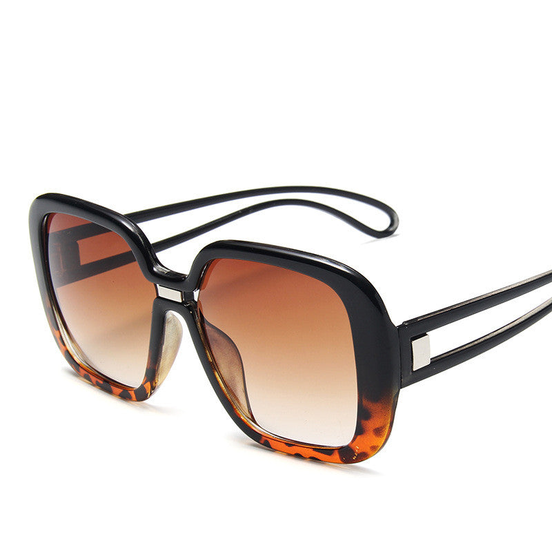 Sunglasses with black frame and tortoiseshell accents on a white background