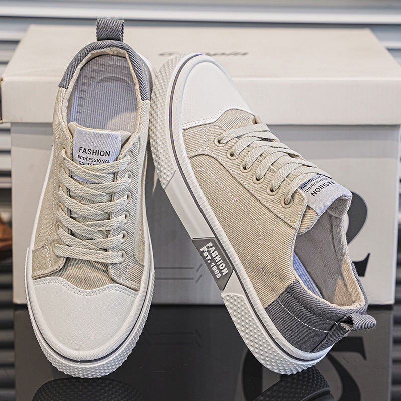 Pair of beige and white sneakers on a reflective surface with a blurred background