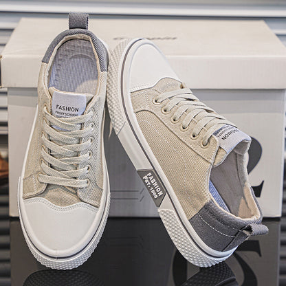 Pair of beige and white sneakers on a reflective surface with a blurred background