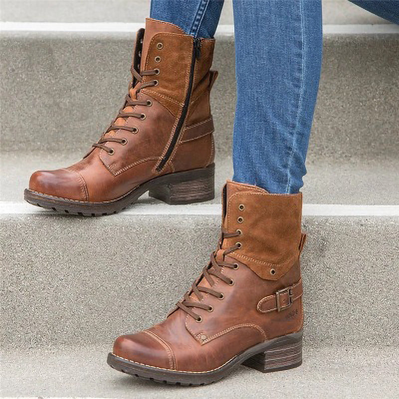 Brown leather boots with a buckle on a concrete step