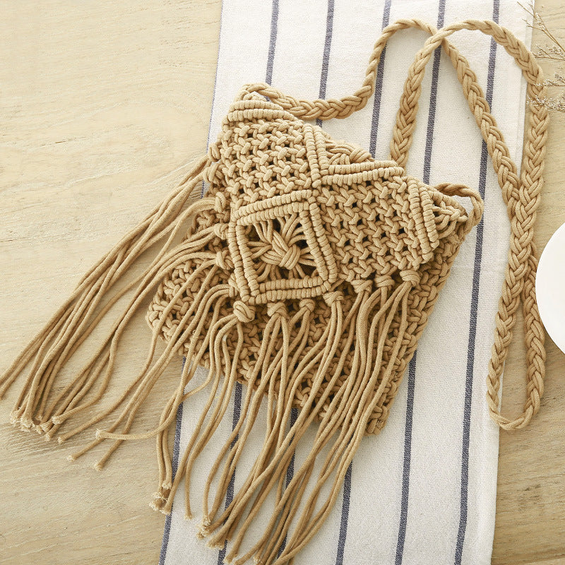 Macrame bag with fringes on a striped fabric background