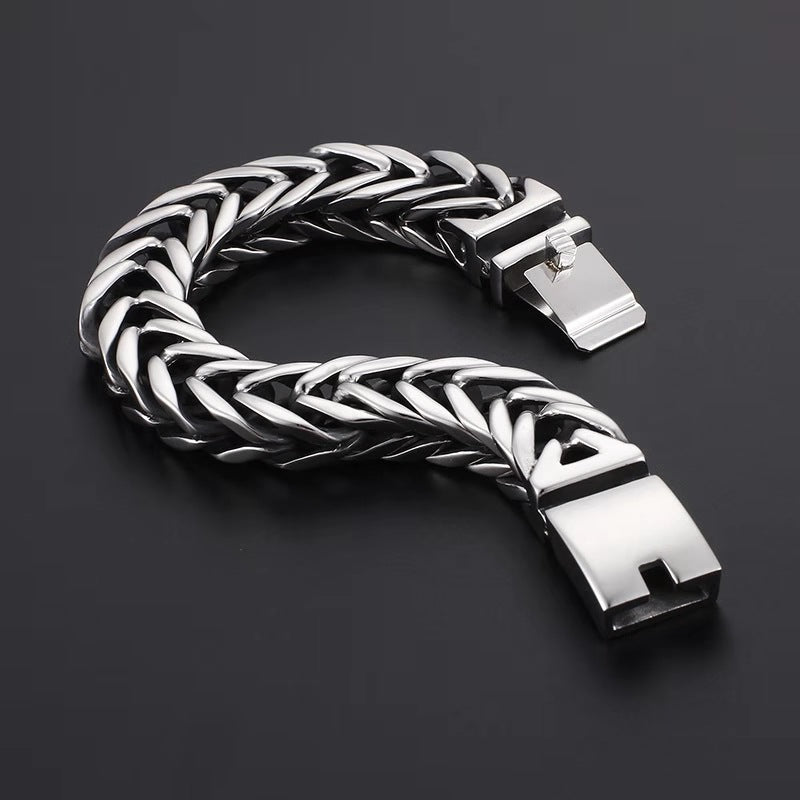 Silver braided bracelet on a dark background