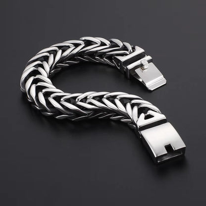Silver braided bracelet on a dark background