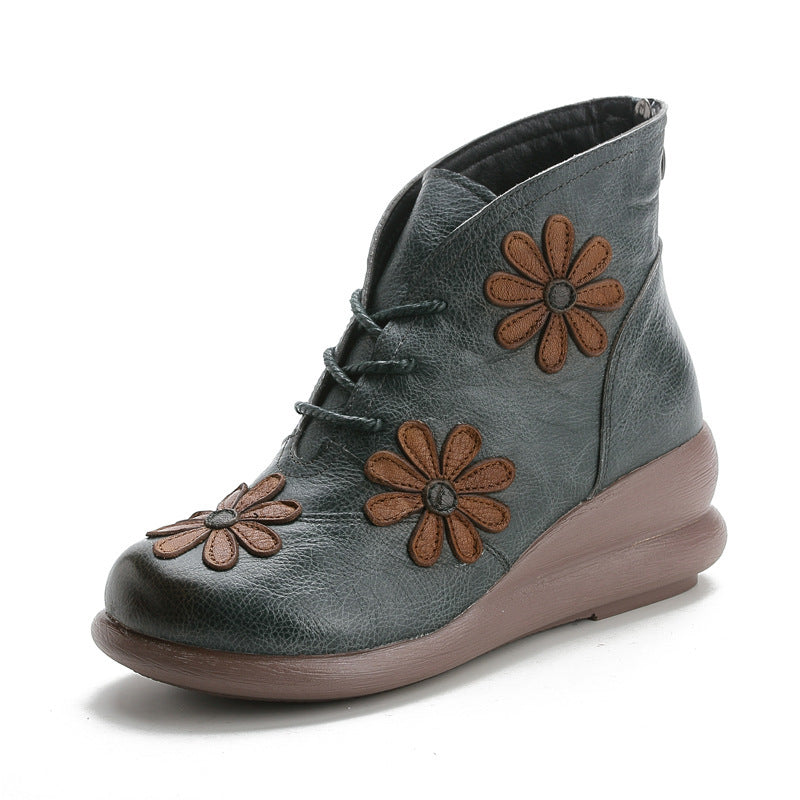 Gray ankle boot with brown flower appliqués on a white background
