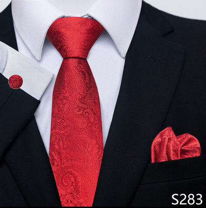 Red paisley tie and matching pocket square with a black suit and white shirt.