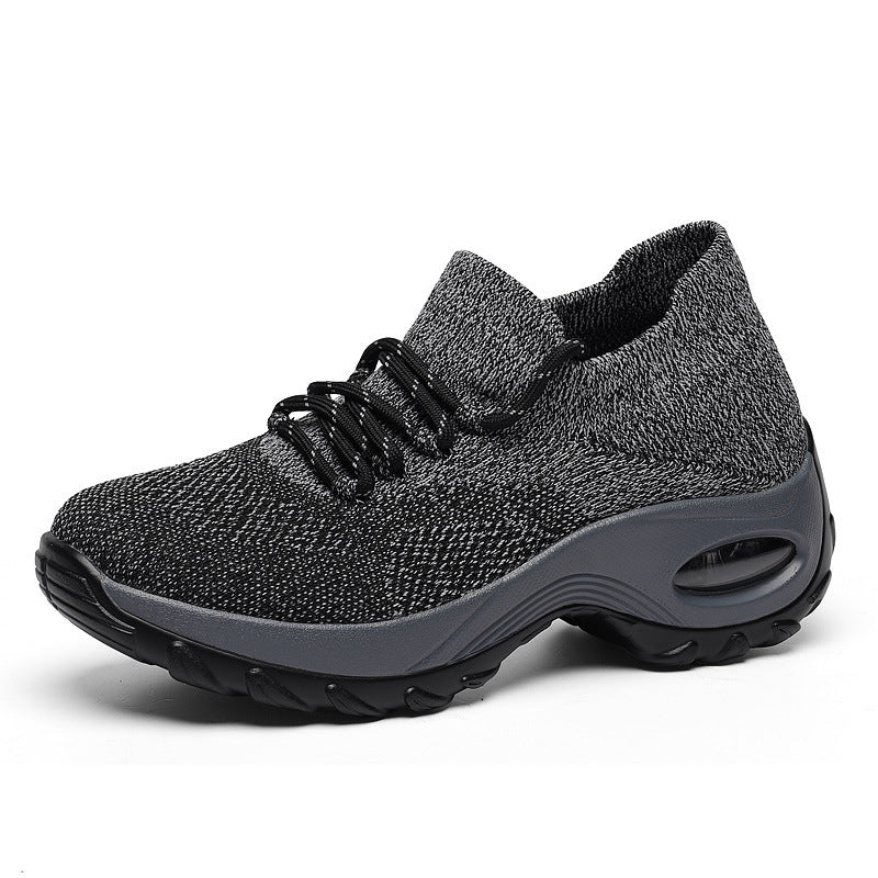 Gray athletic shoe with black laces on a white background