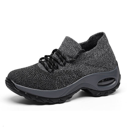 Gray athletic shoe with black laces on a white background