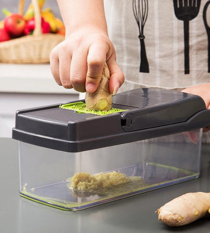 7-in-1 black vegetable cutter slicing green cucumber into clear collection box
