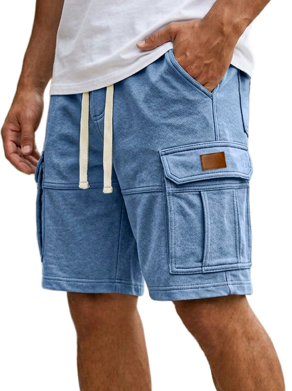 Blue cargo shorts with a white shirt worn by a person on a white background