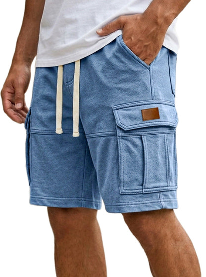 Blue cargo shorts with a white shirt worn by a person on a white background