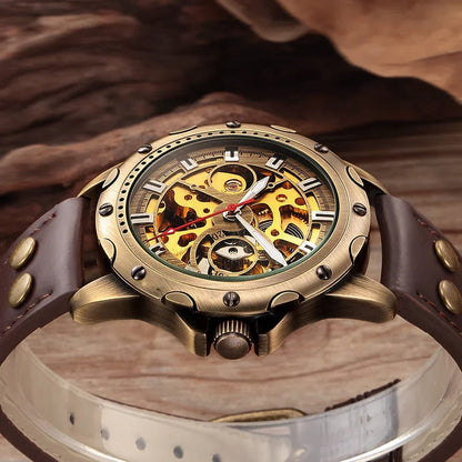 Bronze-tone automatic skeleton watch with dark brown leather strap, close-up gold dial view