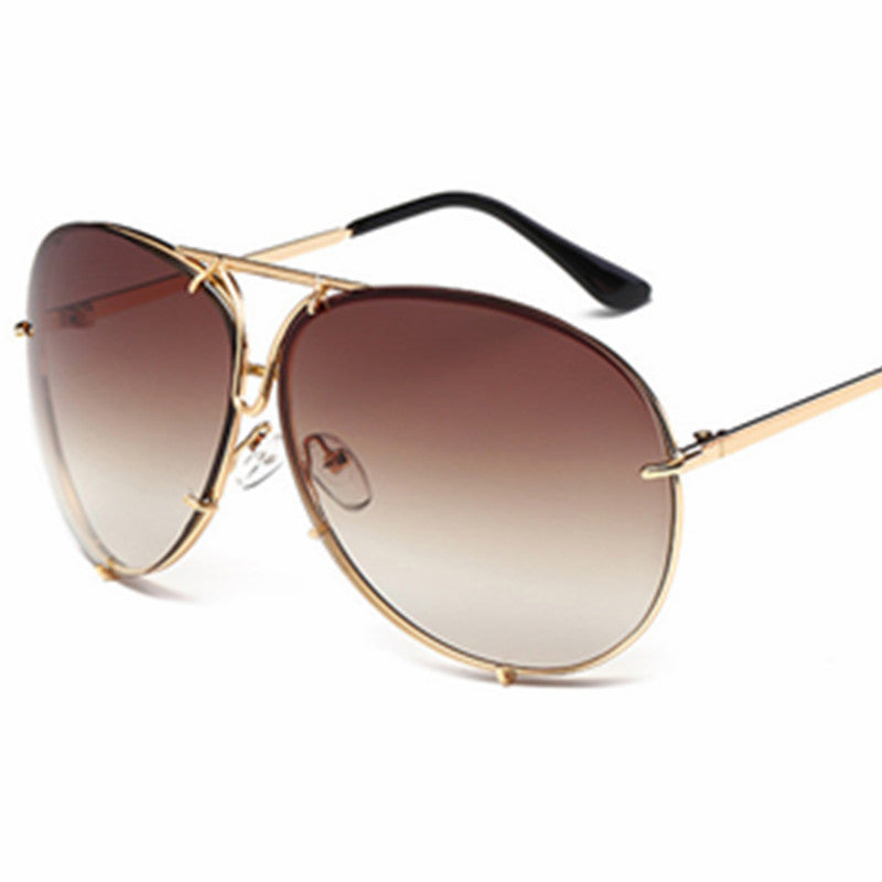 Aviator sunglasses with gold frame and brown gradient lenses on a white background