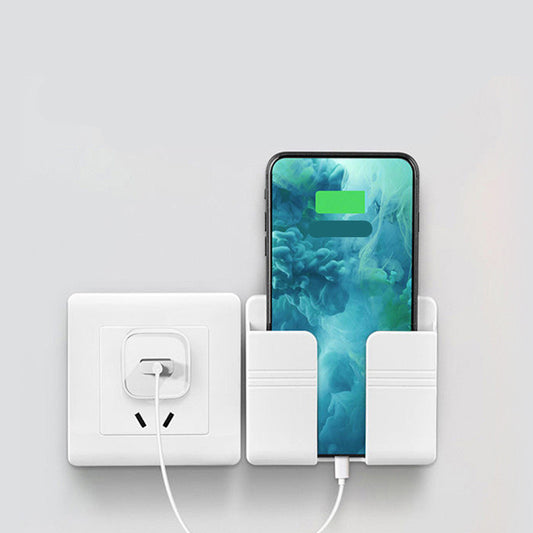 Phone charging station with smartphone and power outlet on a light gray background