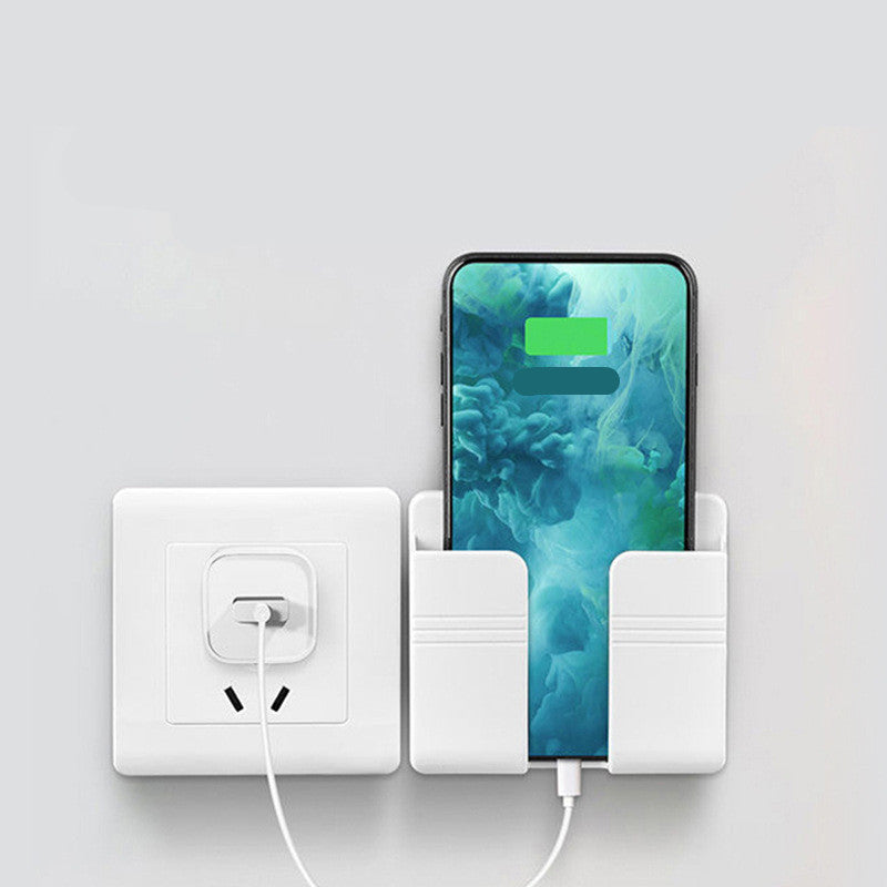 Phone charging station with phone, card holder, and power outlet on a light gray background