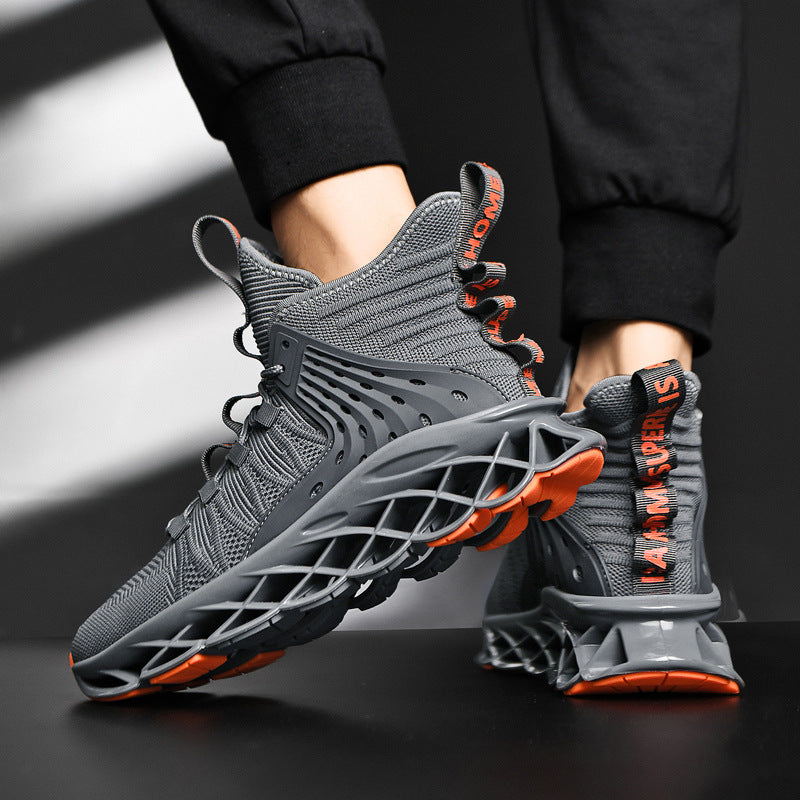 Gray sneakers with orange accents worn by a person on a dark background