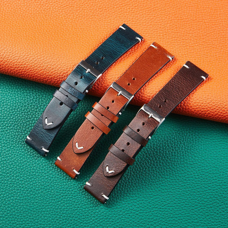 Assorted leather watch straps with silver buckles in orange, teal, tan, and brown