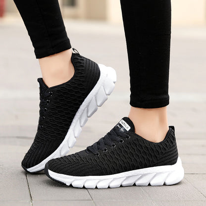 Black and white sneakers worn on a blurred background