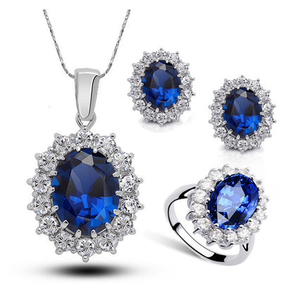 Jewelry set with blue gemstones on a white background