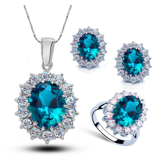 Jewelry set with blue gemstones on a white background