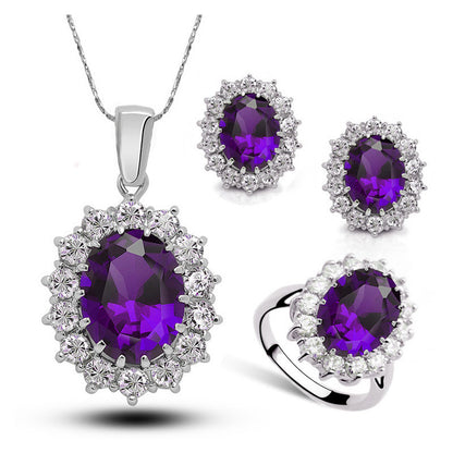 Jewelry set with purple gemstones on a white background