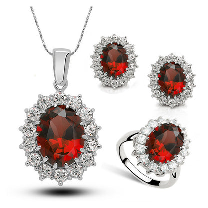 Jewelry set with red gemstones and silver accents on a white background