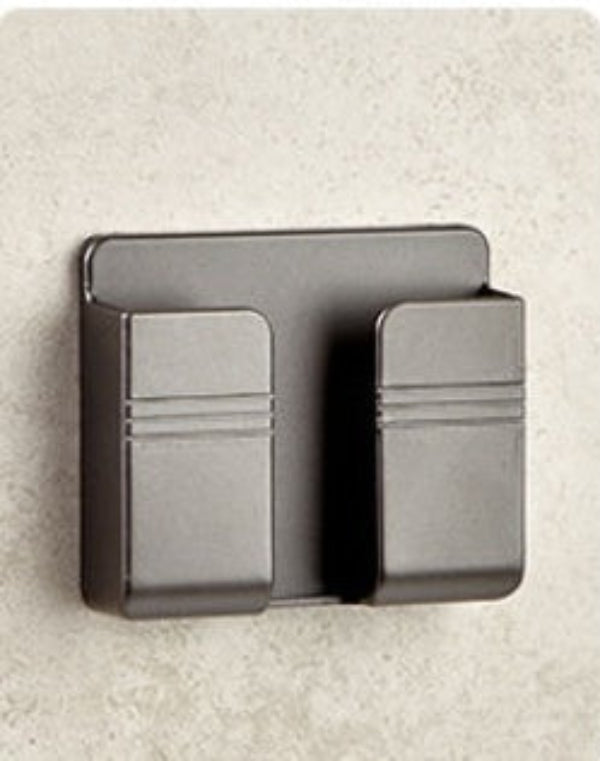 Black metal wall-mounted card holder on a beige wall