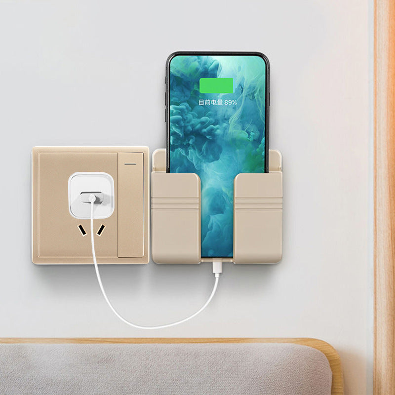 Phone charging station with a smartphone plugged into it, next to an electrical outlet.
