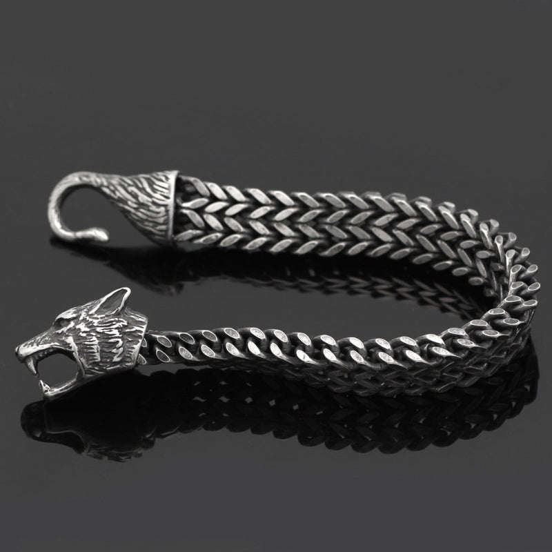 Silver braided belt with wolf head design on a black background