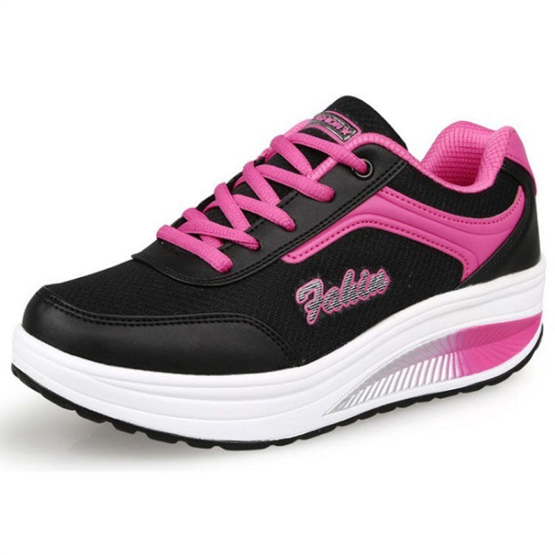 Black and pink running shoe with 'Fabletics' branding on a white background