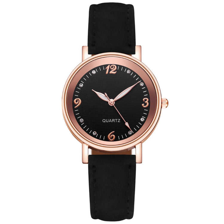 Black wristwatch with rose gold case and black strap on white background