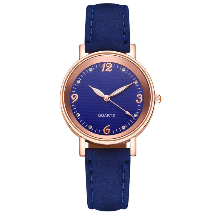 Wristwatch with blue strap and rose gold case on white background