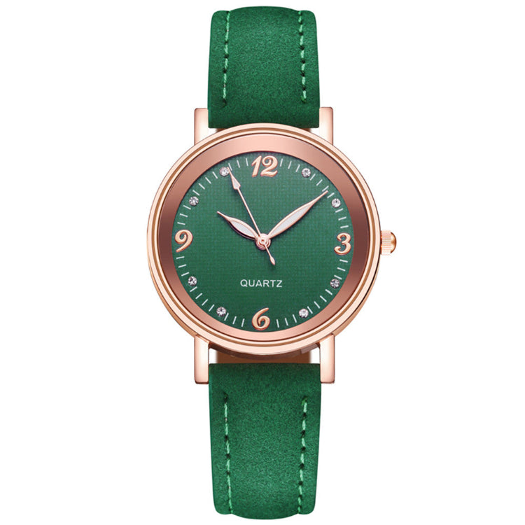 Green watch with rose gold case and green strap on white background