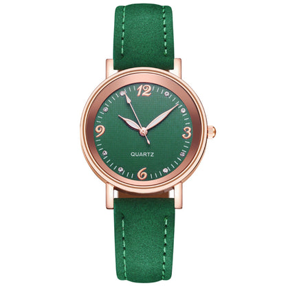 Green watch with rose gold case and green strap on white background