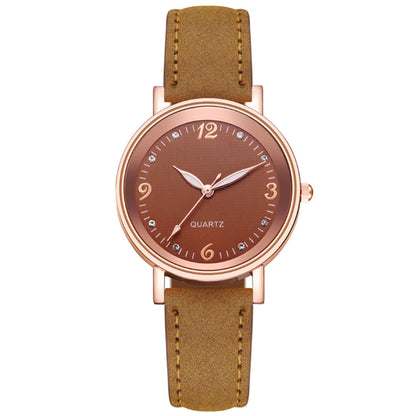 Wristwatch with brown leather strap and rose gold case on white background