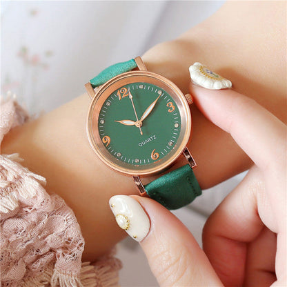 Women's quartz watch with green dial, gold-tone case, and green leather strap