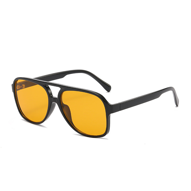 Sunglasses with black frame and yellow lenses on a white background