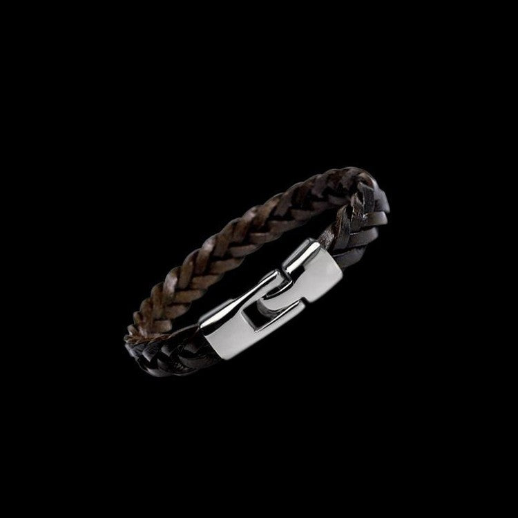 Bracelet with braided design and metallic clasp on a black background