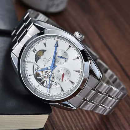 Men's mechanical hollow-dial watch, white face, blue hands, steel bracelet, angled