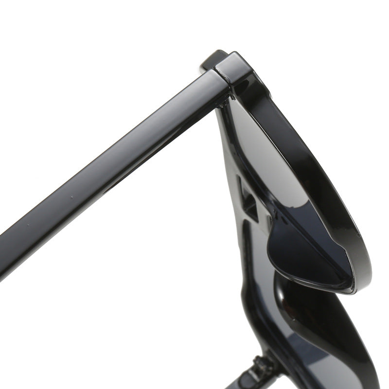 Close-up of a black motorcycle handlebar with mirror on a white background