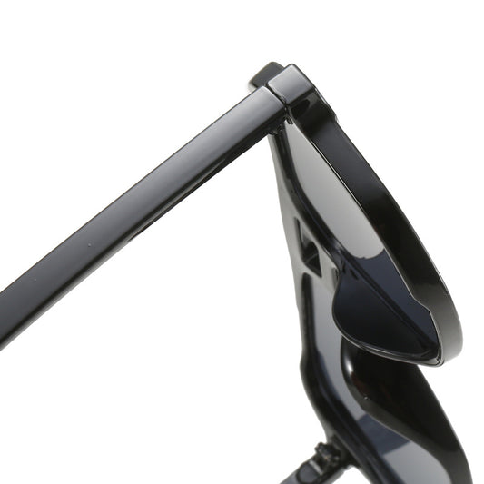 Close-up of a black motorcycle handlebar with mirror on a white background