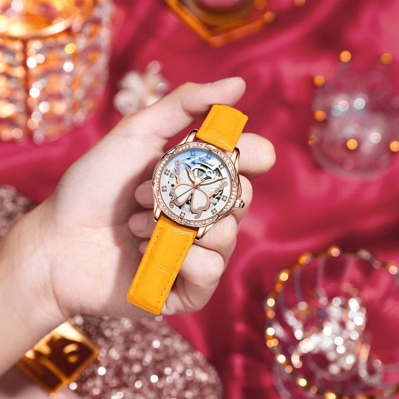 Yellow-orange strap round mechanical watch with diamond bezel and butterfly dial