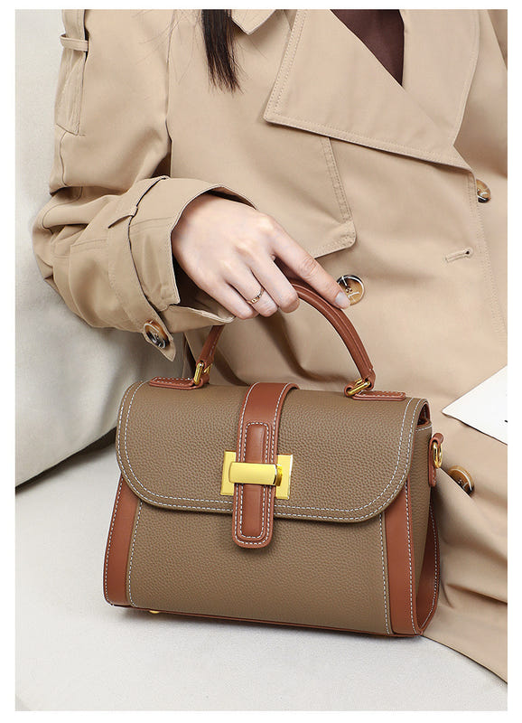 Women’s leather handbag held at front, camel textured body, contrast trim, gold square clasp