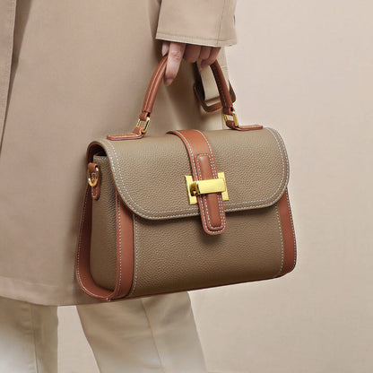 Women’s leather handbag with flap and handles, camel color, contrast brown piping, gold clasp