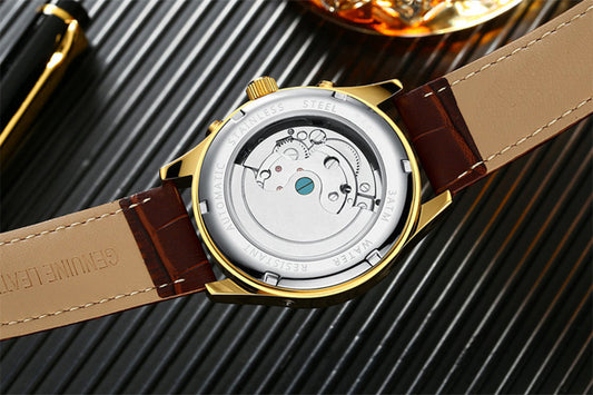 Close-up of a watch with a brown leather strap on a textured surface