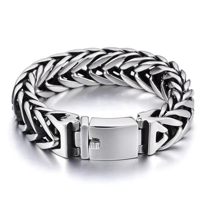 Silver braided bracelet with a clasp on a white background